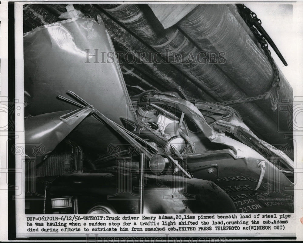 1956 Press Photo Truck Driver Emory Adams Pinned Beneath Load Of Steel Pipe - Historic Images