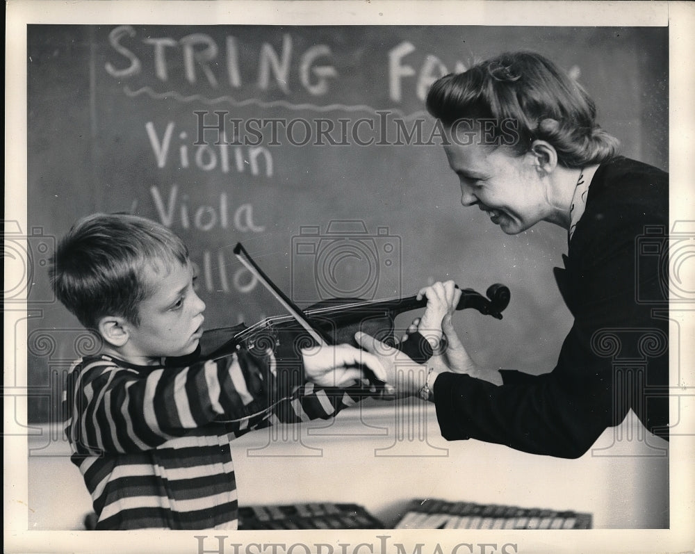 1949 Mr. Alden teaching Ben Crutchfield the violin  - Historic Images