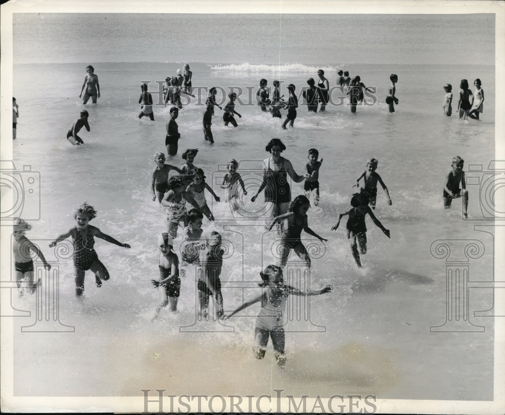 1940 Public school children playing on the beach - Historic Images