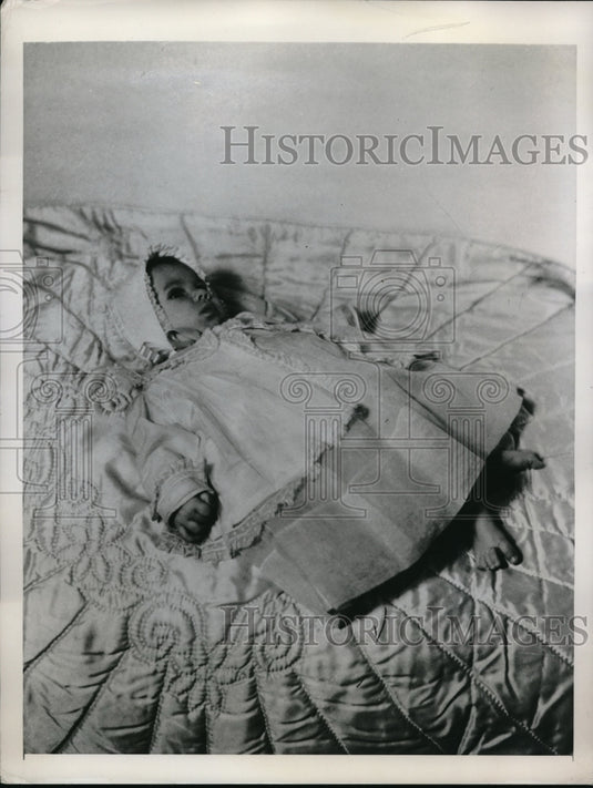 1948 Baby laying down on a bed - Historic Images