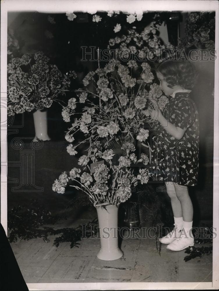 1937 Carol KWilliams of NY smells &quot;Duchess of Glouschester&quot; flowers - Historic Images