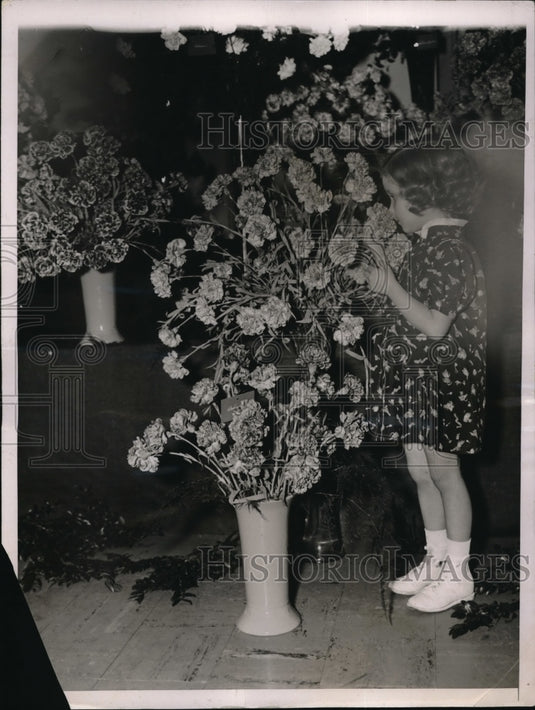 1937 Carol KWilliams of NY smells "Duchess of Glouschester" flowers - Historic Images