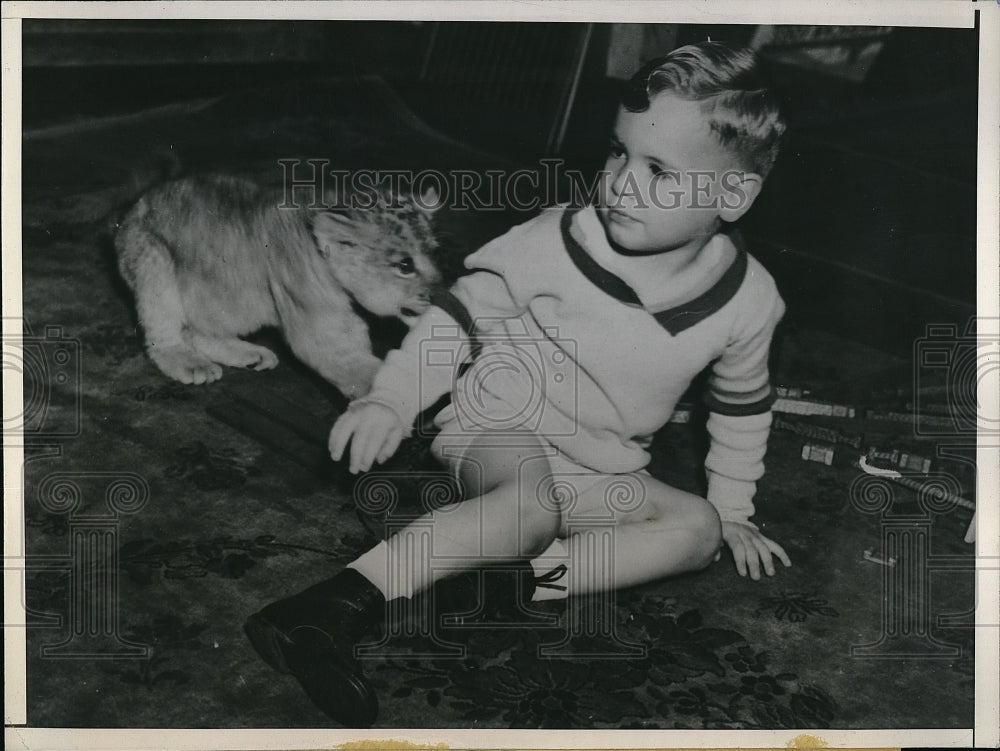 1943 Young Sonny Helmboe with Baby Lion Pet - Historic Images