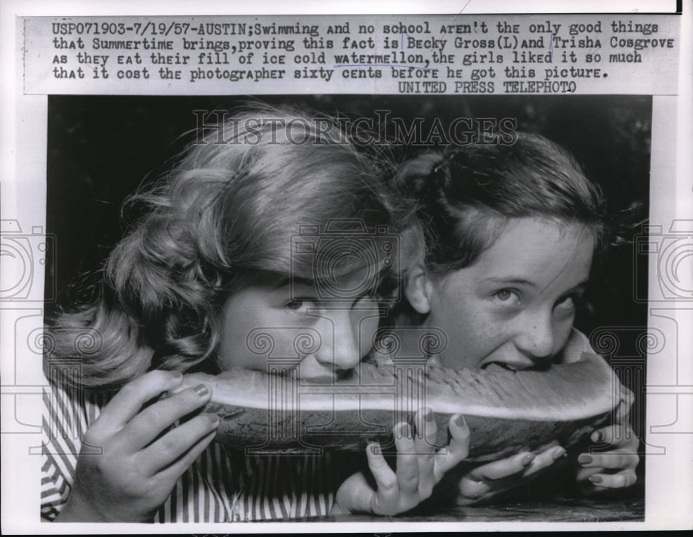 1957 Becky Gross and Trisha Cosgrove eating watermelon in the summer - Historic Images