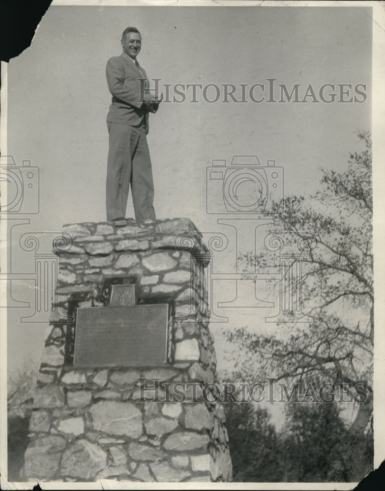 1931 Press Photo Publisher George Monell on a rock cairn - Historic Images