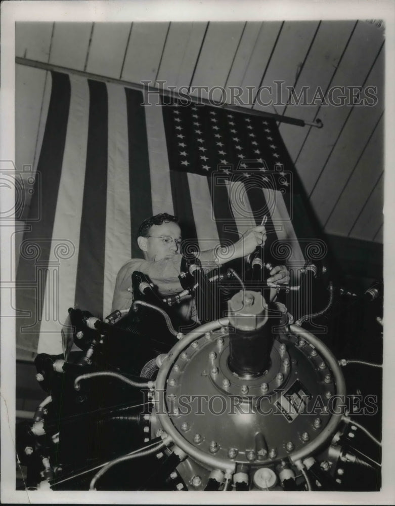 1941 Workman at North American Aviation Company works on motor - Historic Images