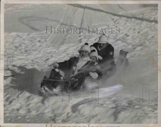 1937 Press Photo Family sledding down snowy hill - Historic Images