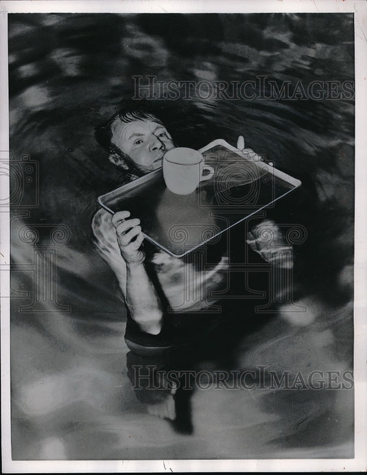 1957 Oliver Johnson Holds Tray & Cup Level Above Water - Historic Images
