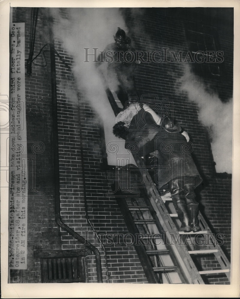 1949 Firemen rescue people from burning building - Historic Images