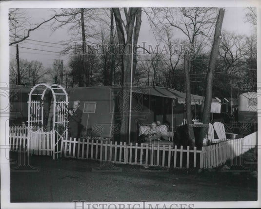 1952 Arthur Diver putters w/ rose trellis outside his mobile home in - Historic Images
