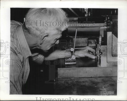 1941 A man working with a piece of machinery-Historic Images