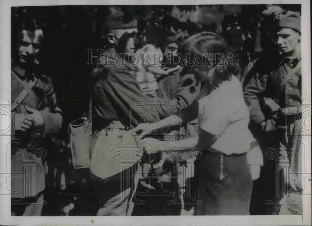 1939 Polish women put a package in her Soldiers husband departing.-Historic Images