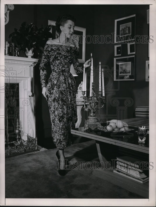 A woman lighting candles at her home's livingroom-Historic Images