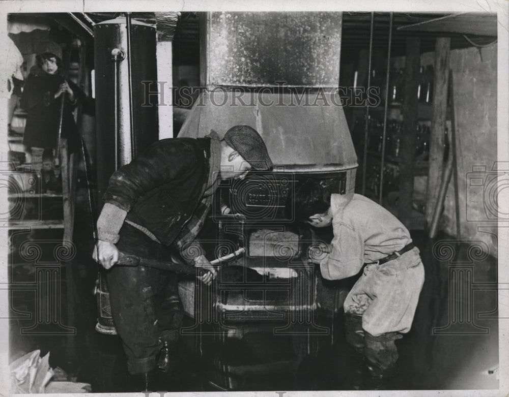 1934 Wm Meacher &amp; Seymour Siegel stoke a furnace at their NY home - Historic Images