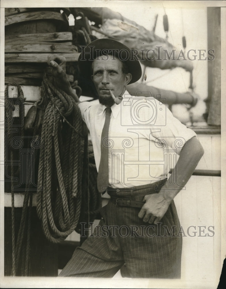 1930 Press Photo Capt Fred Anderson on the dock of his fishing boat, smoking - Historic Images