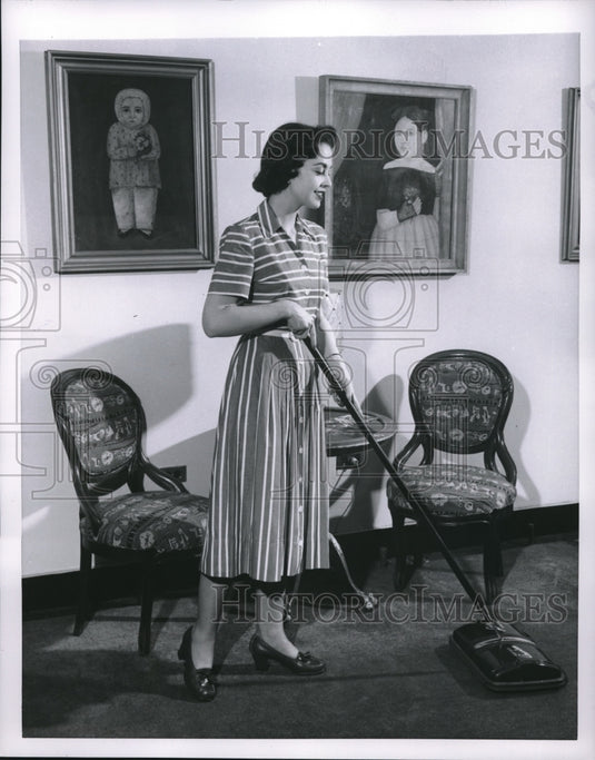 1954 Woman demos proper way to vacuum a carpet at home-Historic Images