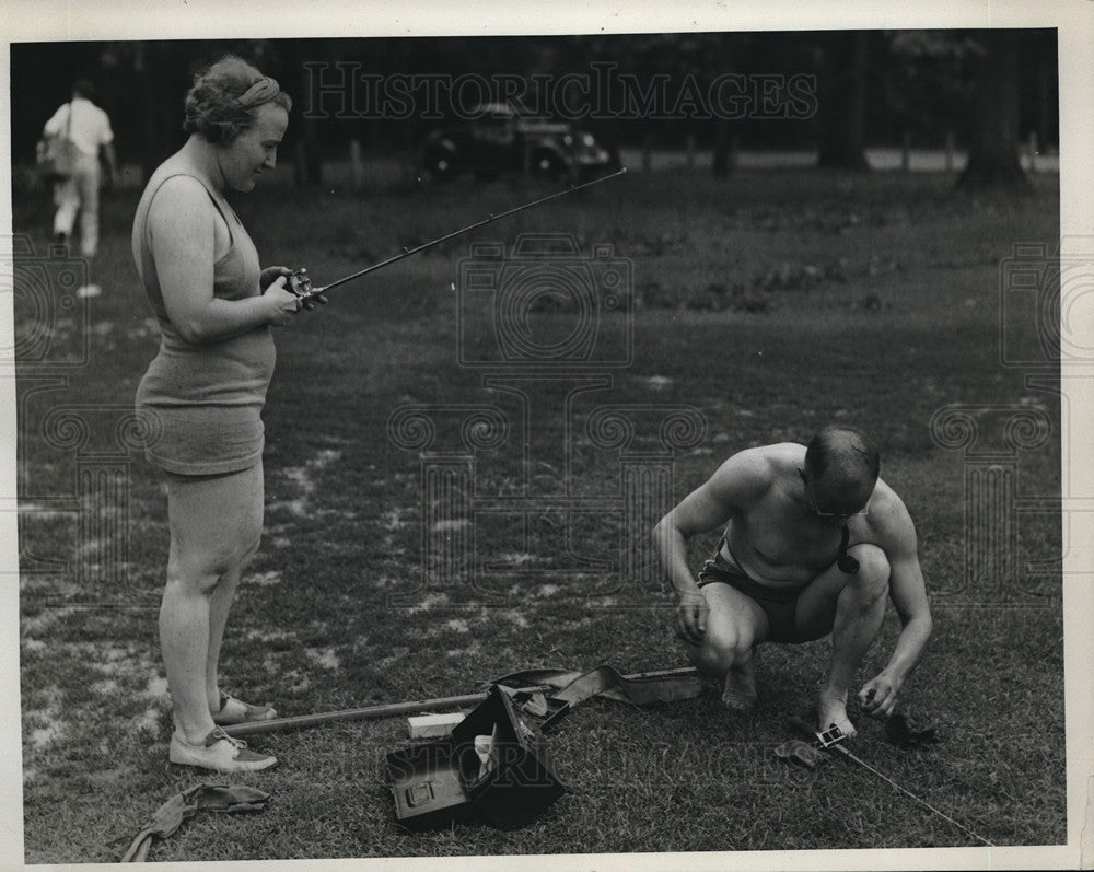 1937 Press Photo Man and woman prepare fishing poles - neb69449 - Historic Images