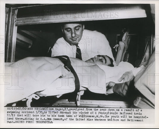 Press Photo William Hager, Paralyzed is Lifted into Train by G.A. Van Gemert - Historic Images