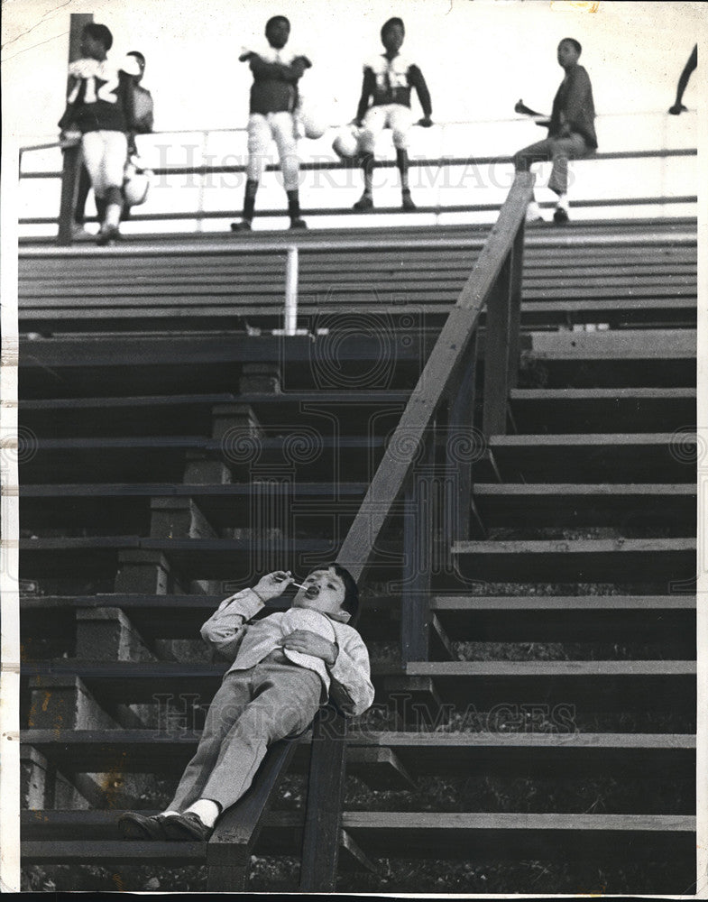 1971 Benton Arkansas Stadium Child Relaxing Before Game - Historic Images