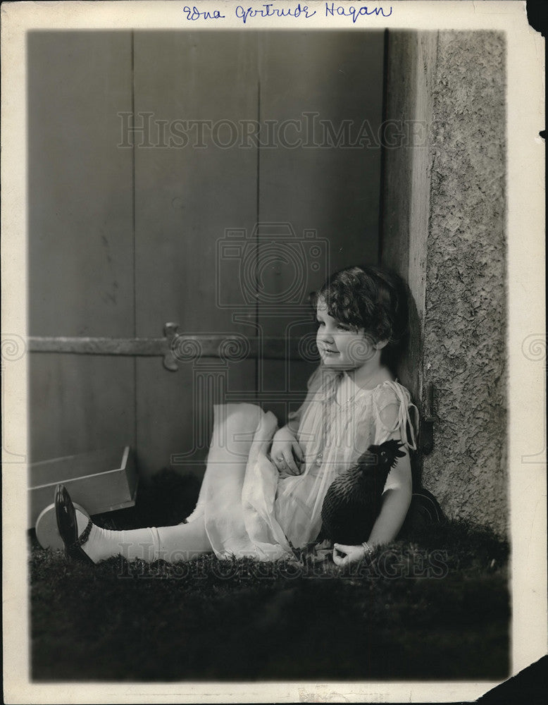 1928 A child model in a sitting pose in dress  - Historic Images