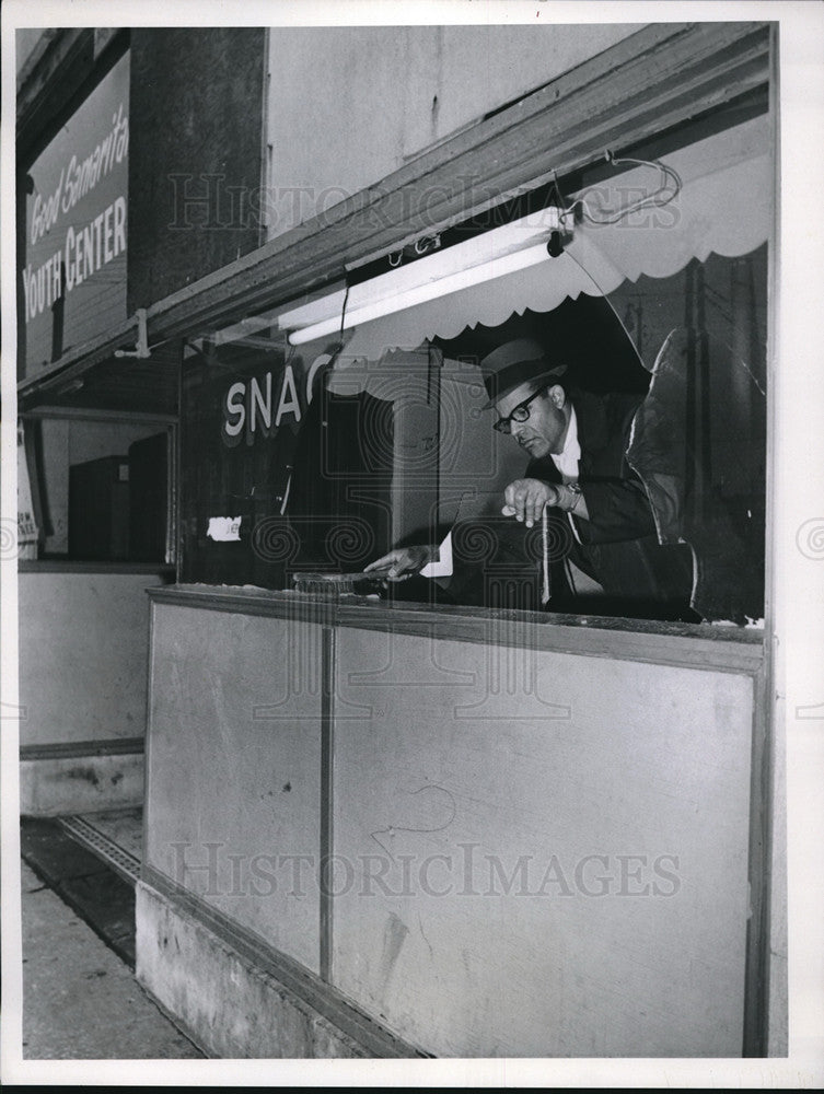 1967 Press Photo Man sweeping out the window at local store - Historic Images