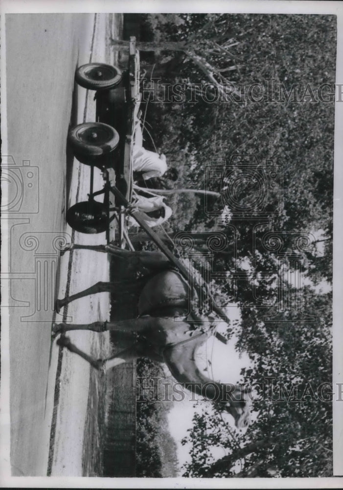 1954 Natives of Delhi riding a camel driven cart in the extreme heat - Historic Images