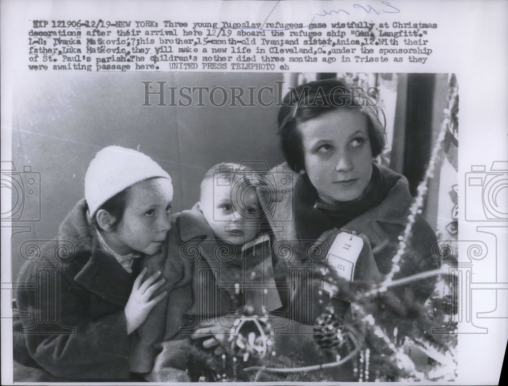 1956 Yugoslav refugees gaze wistfully at Christmas decorations-Historic Images