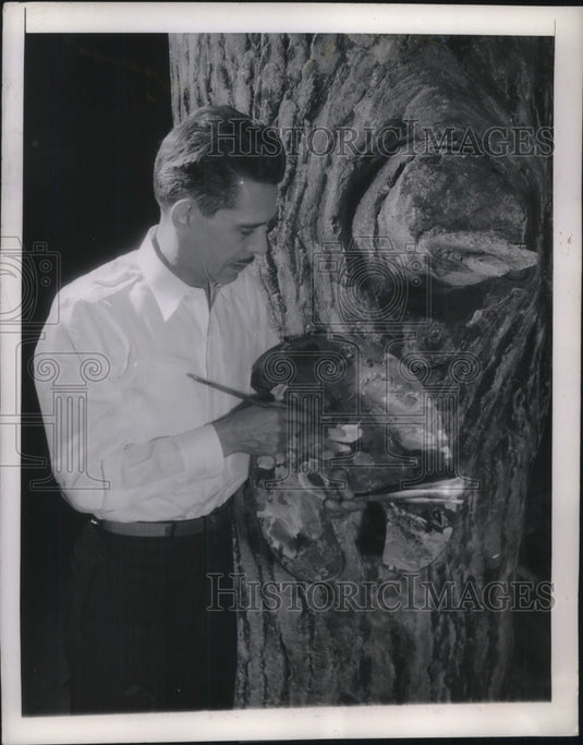 1944 Augusta,ME. artist Beck paining a tree trunk - Historic Images