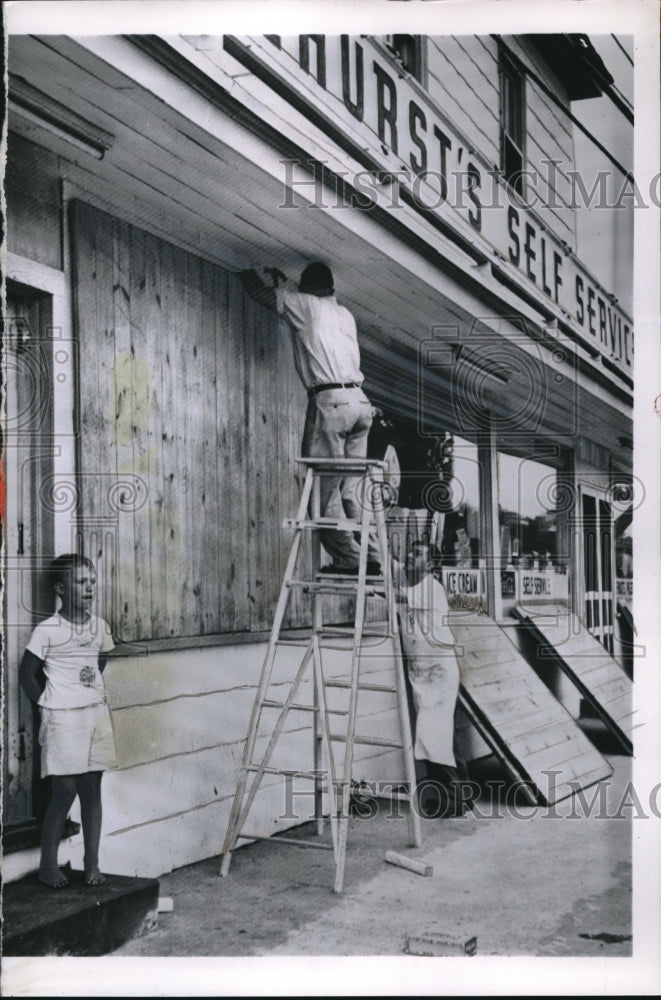 1955 Workers boarding up shop in preparation of Hurricane Connie - Historic Images