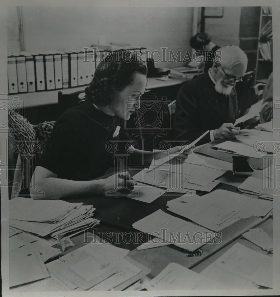 1940 Two people working in office in Geneva Switzerland - Historic Images