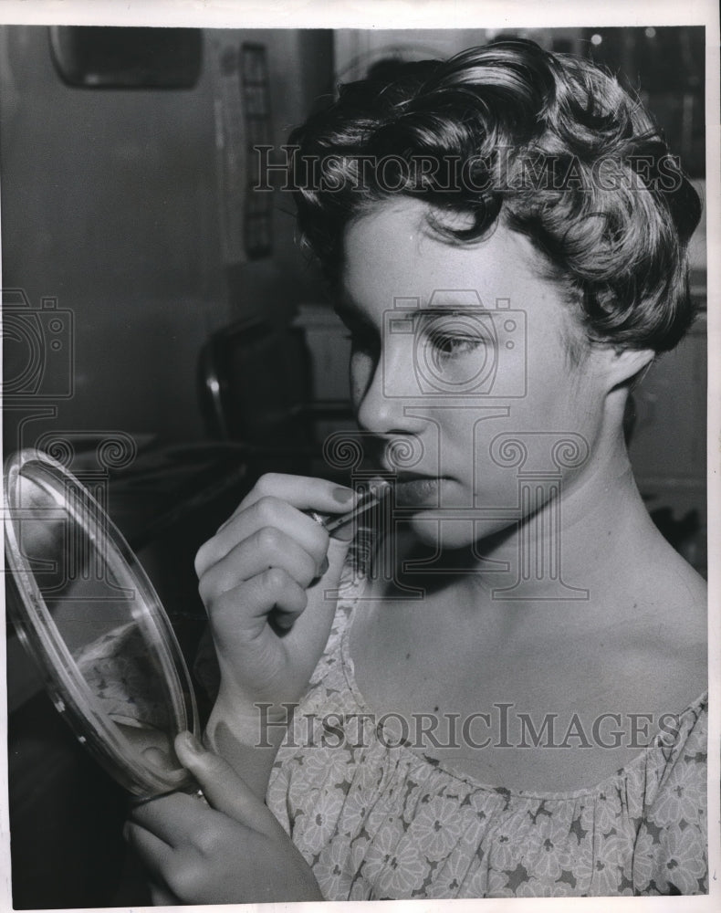 1957 Mary putting on makeup after getting her hair cut - Historic Images