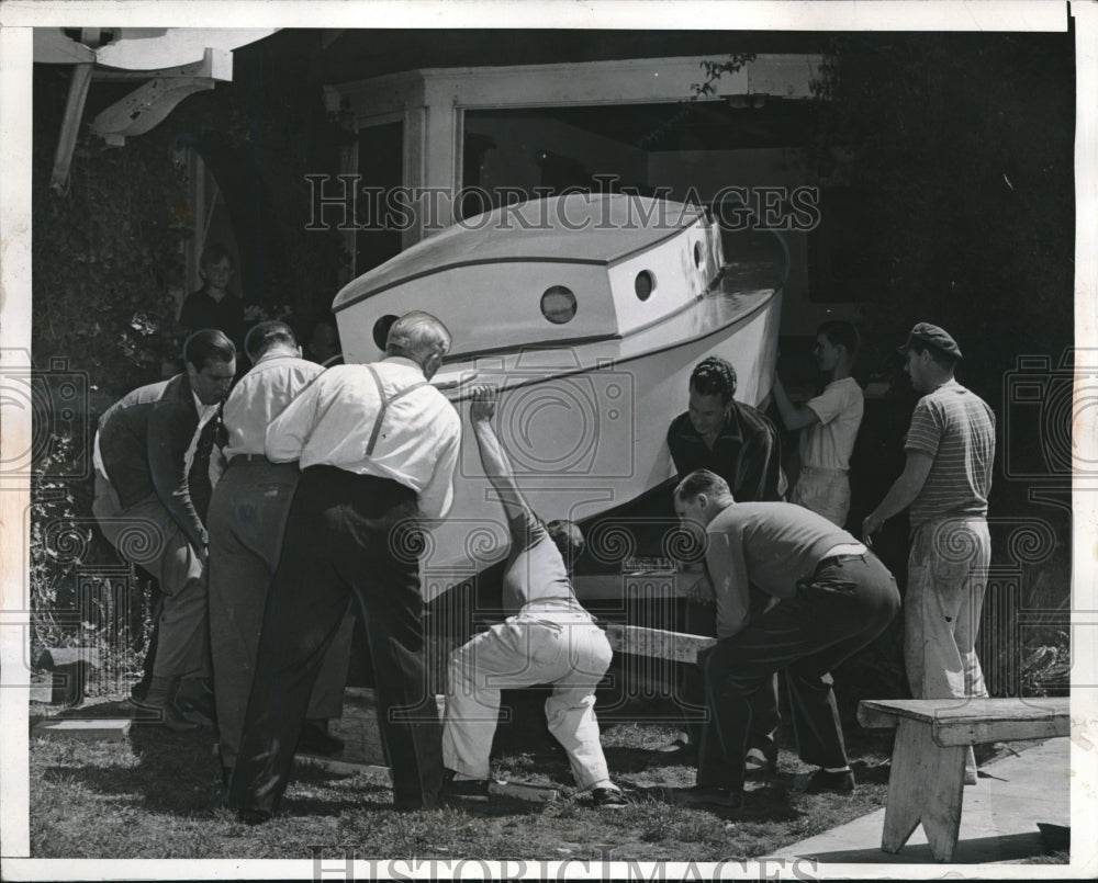 1942 John Negus and his neighbors launching his 18 foot ship - Historic Images