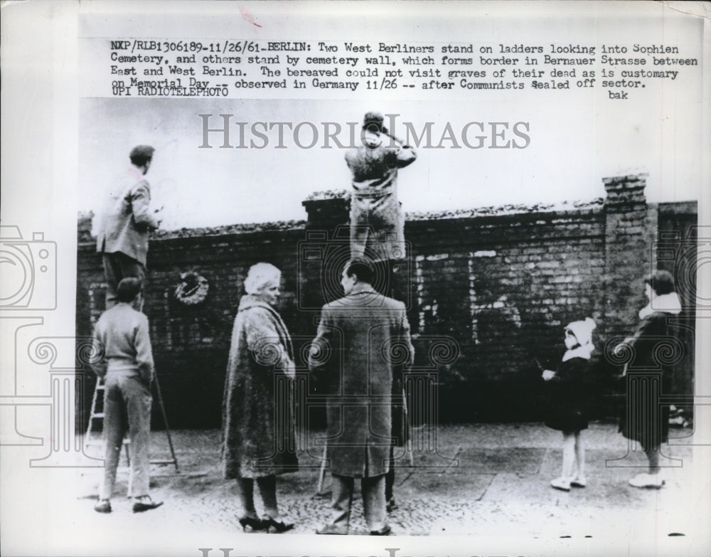 1961 Press Photo 2 West Berliners Looking Into Sovhien Cemetery  Berlinr - Historic Images