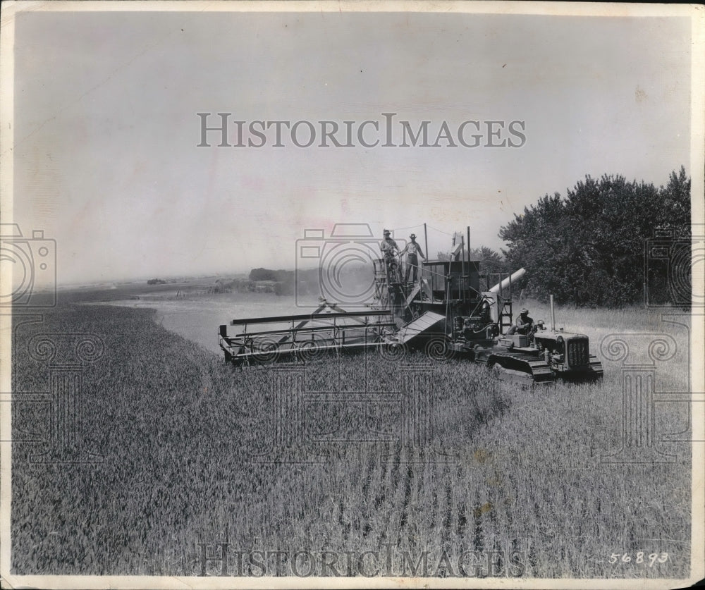 1948 Andrew Boone on combine on his farm  - Historic Images