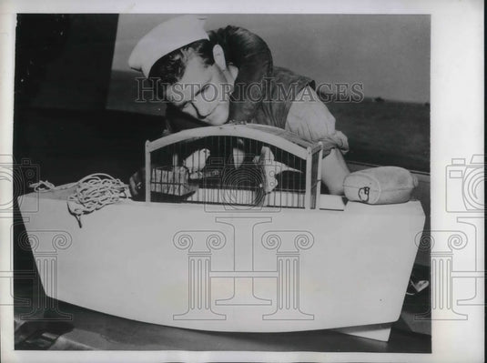 1943 Coast Guardsman Tim McGrath & canaries from a ship - Historic Images