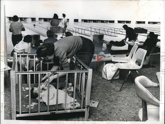 1961 Bowler Mrs. David E. Cavin Quiets Her 11 Month Old With Bottle - Historic Images
