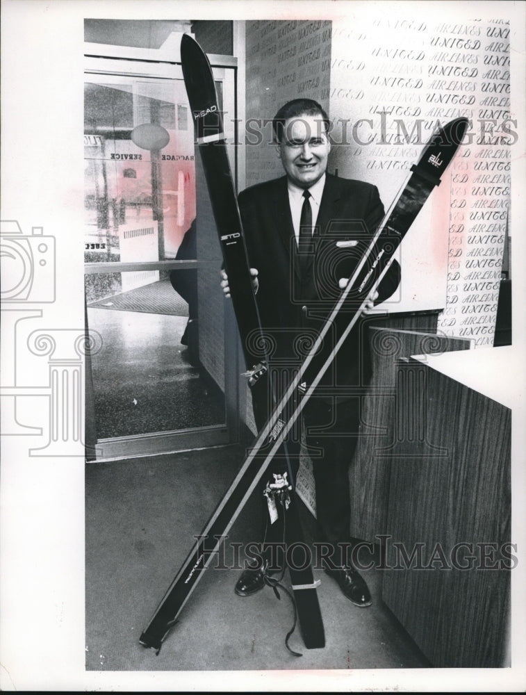 1969 Martin Carm of United Air Lines holding some skis - Historic Images