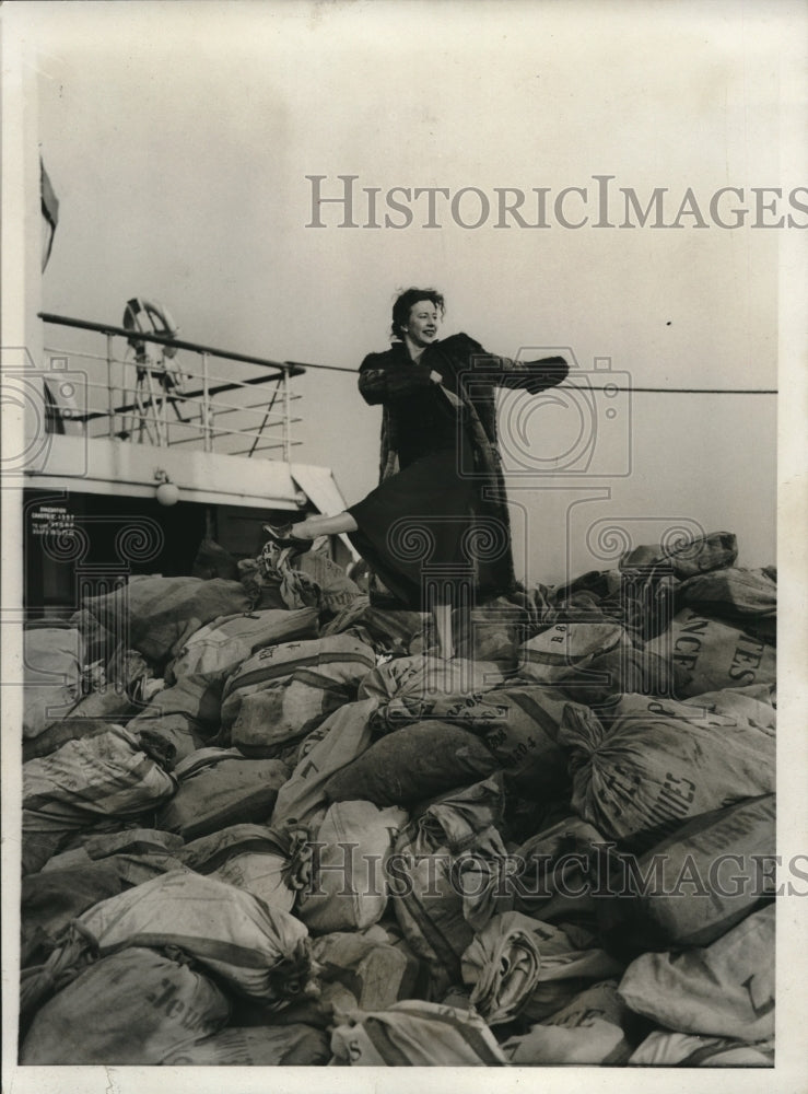 1932 dancer Agnes George De Mille atop mail bags on SS Champlain-Historic Images