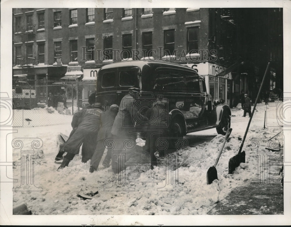 1940 NY city workers helping out a truck out of a snow ditch - Historic Images