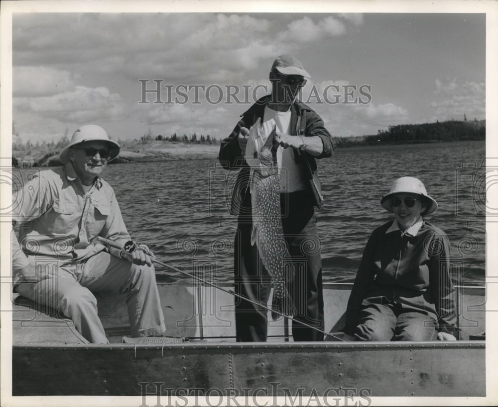 1958 Press Photo A group of people fishin from a boat on a lake - Historic Images