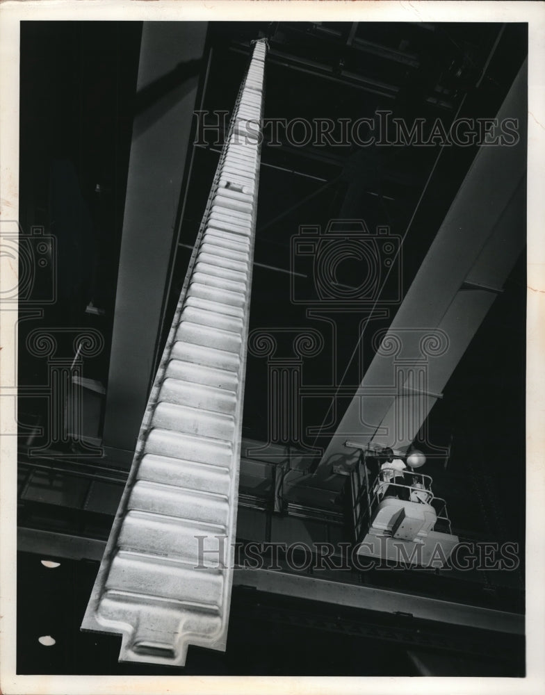 1960 Overhead view of alarge crane in operation at warehouse - Historic Images