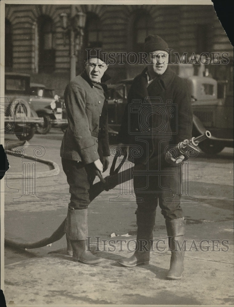 1930 Two firefighters using fire hose-Historic Images