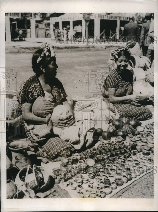 1937 This Guatemalan mother, cradling her infant, at Marketplace - Historic Images