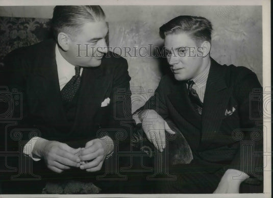 1938 Lynn Waldorf & Bill De Correnout conferring w/ each other - Historic Images