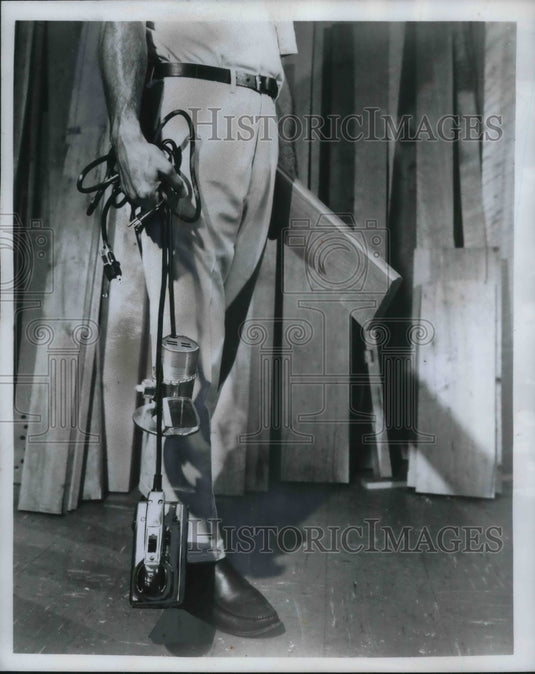 1969 Press Photo Man Illustrates Unsafe Way to Carry Power Tools - by Cords - Historic Images