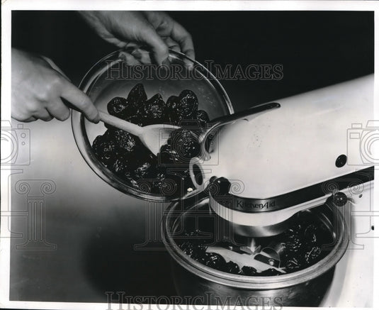 Colander & sieve & an electric mixer demonstrated - Historic Images