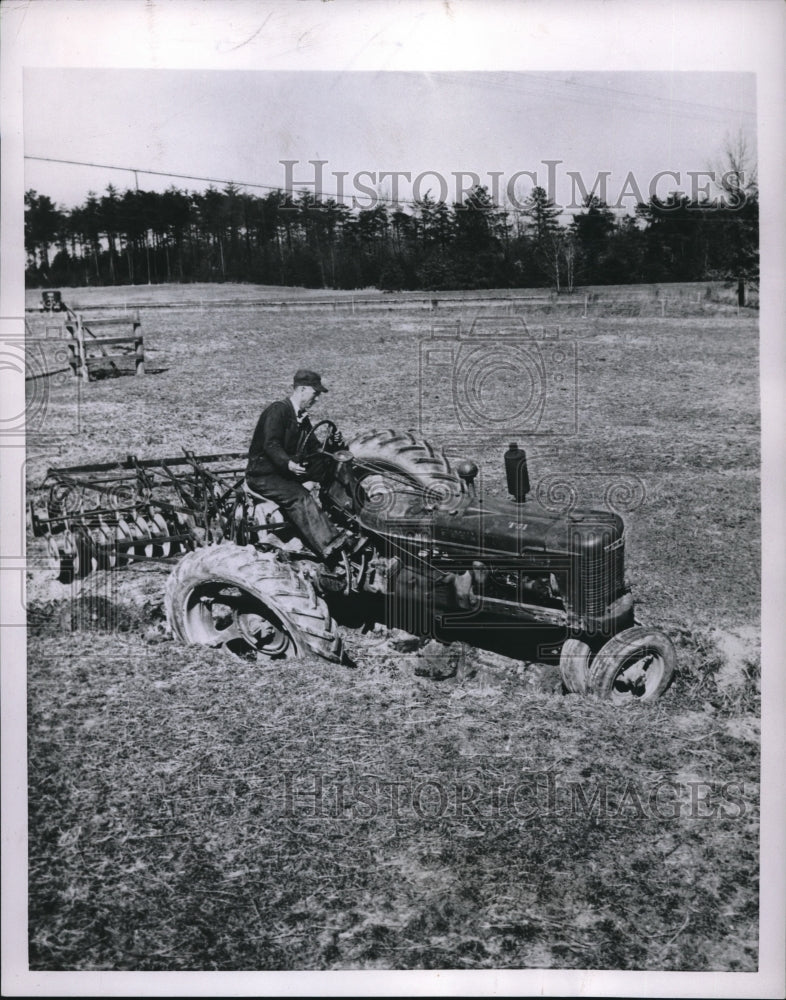 1954 Press Photo A farmer on his tractor caught in a ditch-Historic Images