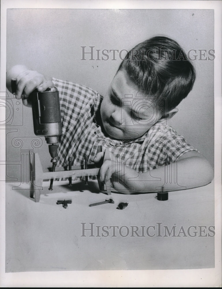 1957 Press Photo Child Boy Plays With Toy Drill Set - Historic Images