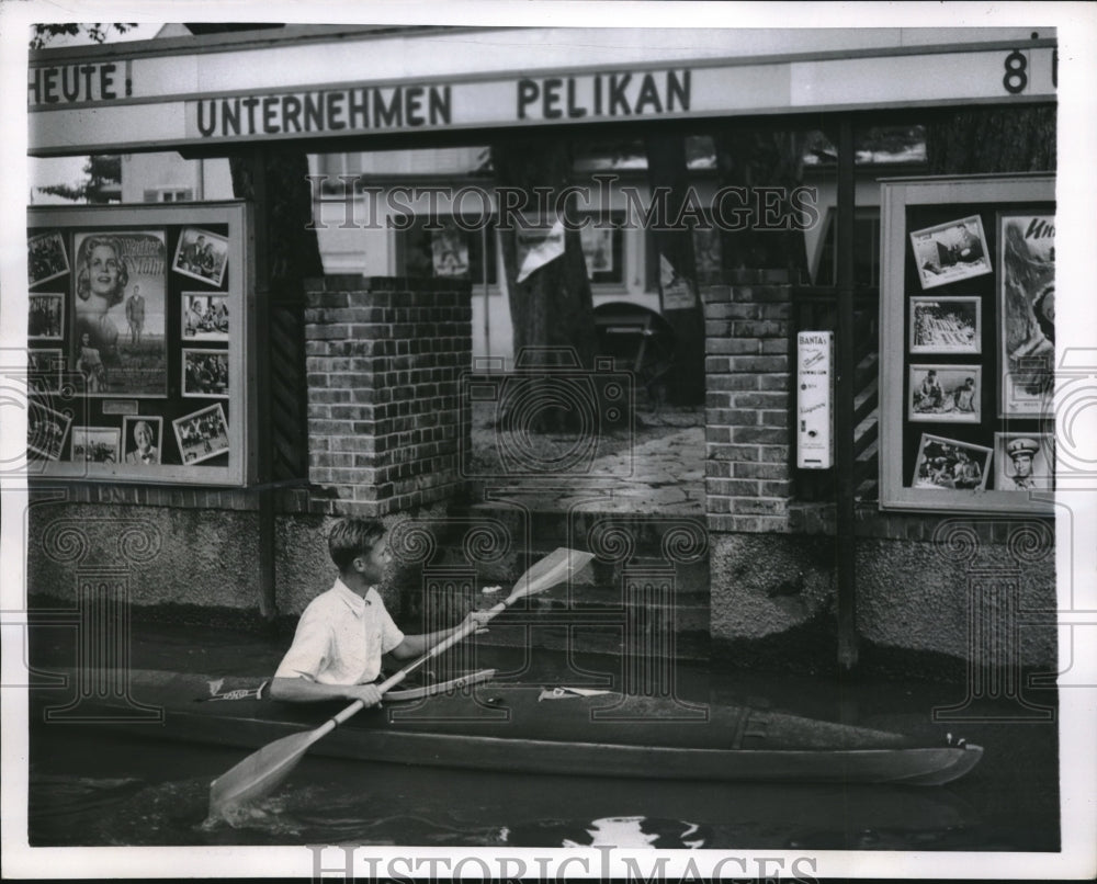 1957 Press Photo youth kayaks in street of flooded Neuhaus, Germany - neb94509 - Historic Images