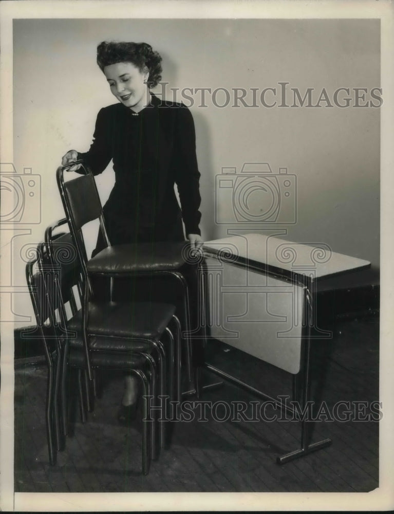 1948 Modern stacking chairs are demonstrated by Loretta Appleman - Historic Images